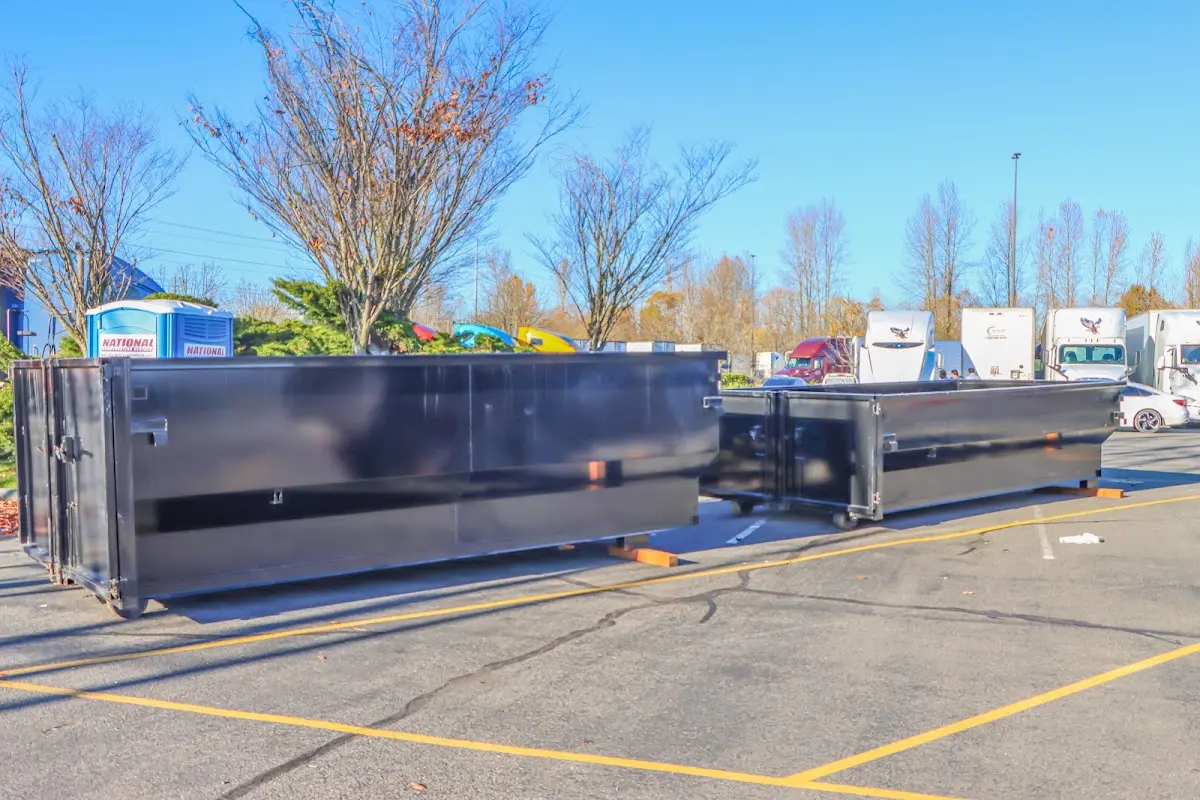 Professional dumpster rental service with roll-off container on residential driveway in Dormont